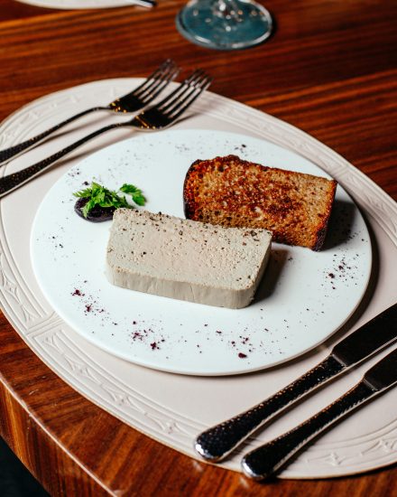 top-view-meal-inside-plate-with-cutlery-brown-wooden-table-food-meal-dinner-restaurant